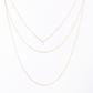 Front and back long necklace featuring three loops with white pearl accents.