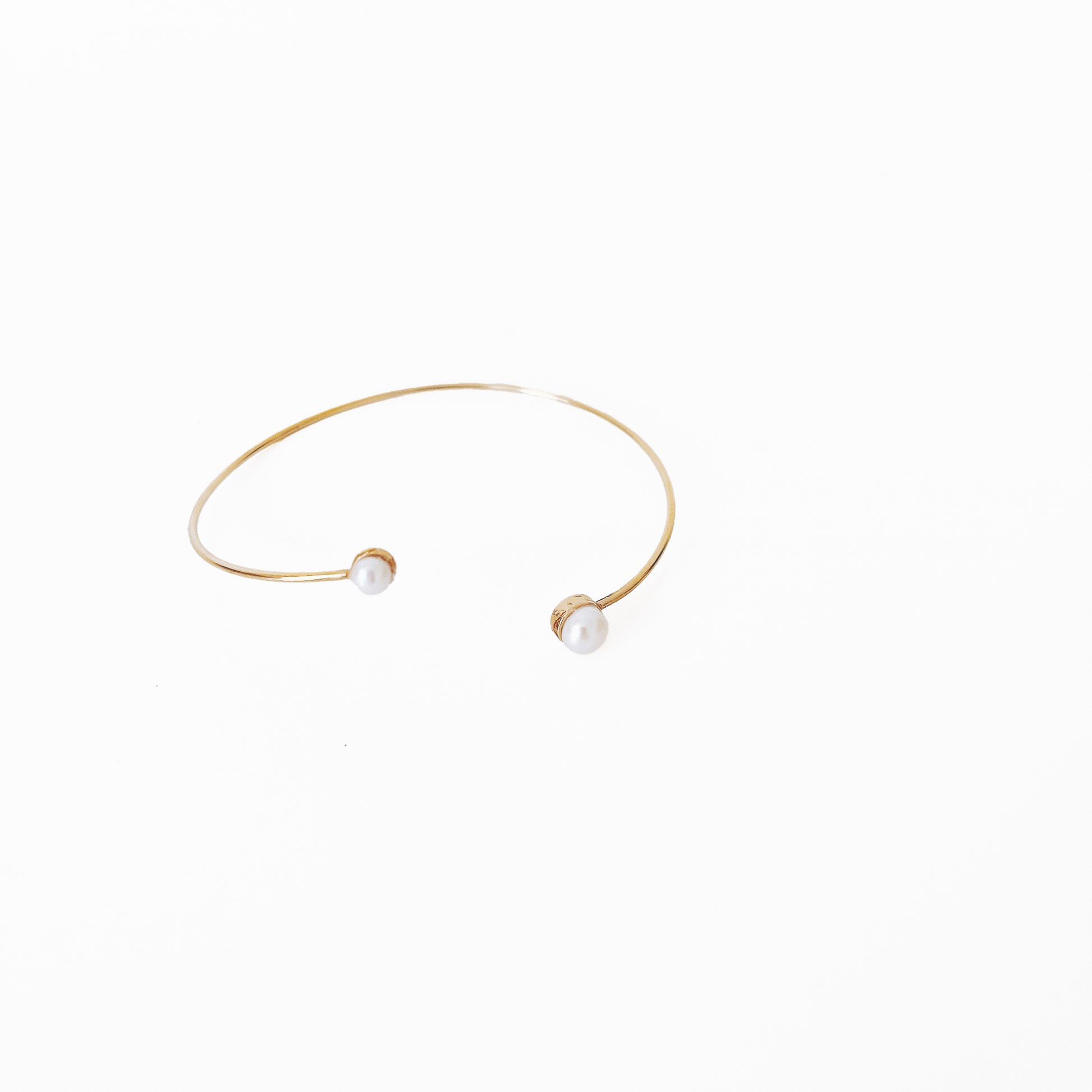 Open gold bracelet adorned with varying sizes of pearls by Hikaru Pearl