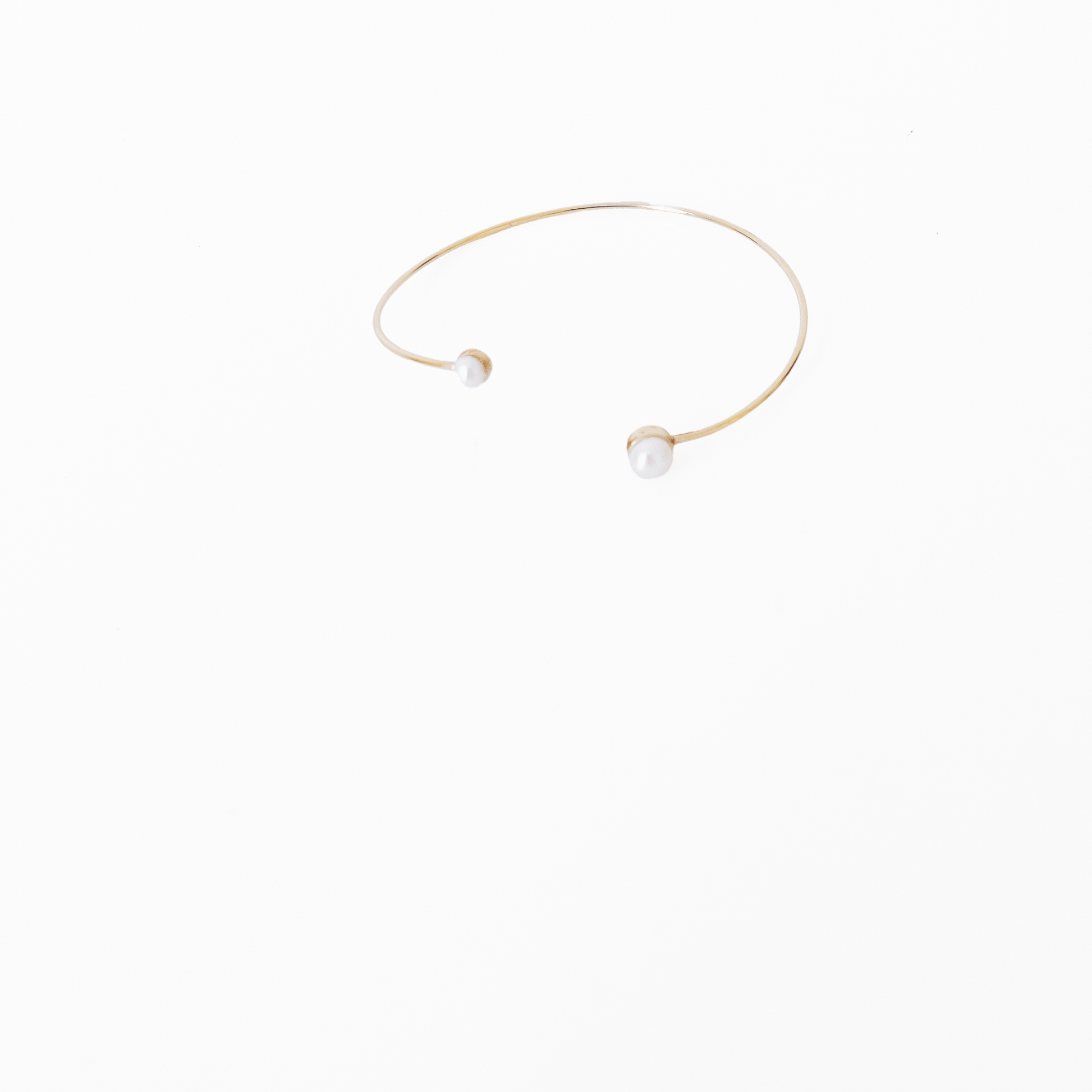 Open gold bracelet adorned with varying sizes of pearls by Hikaru Pearl