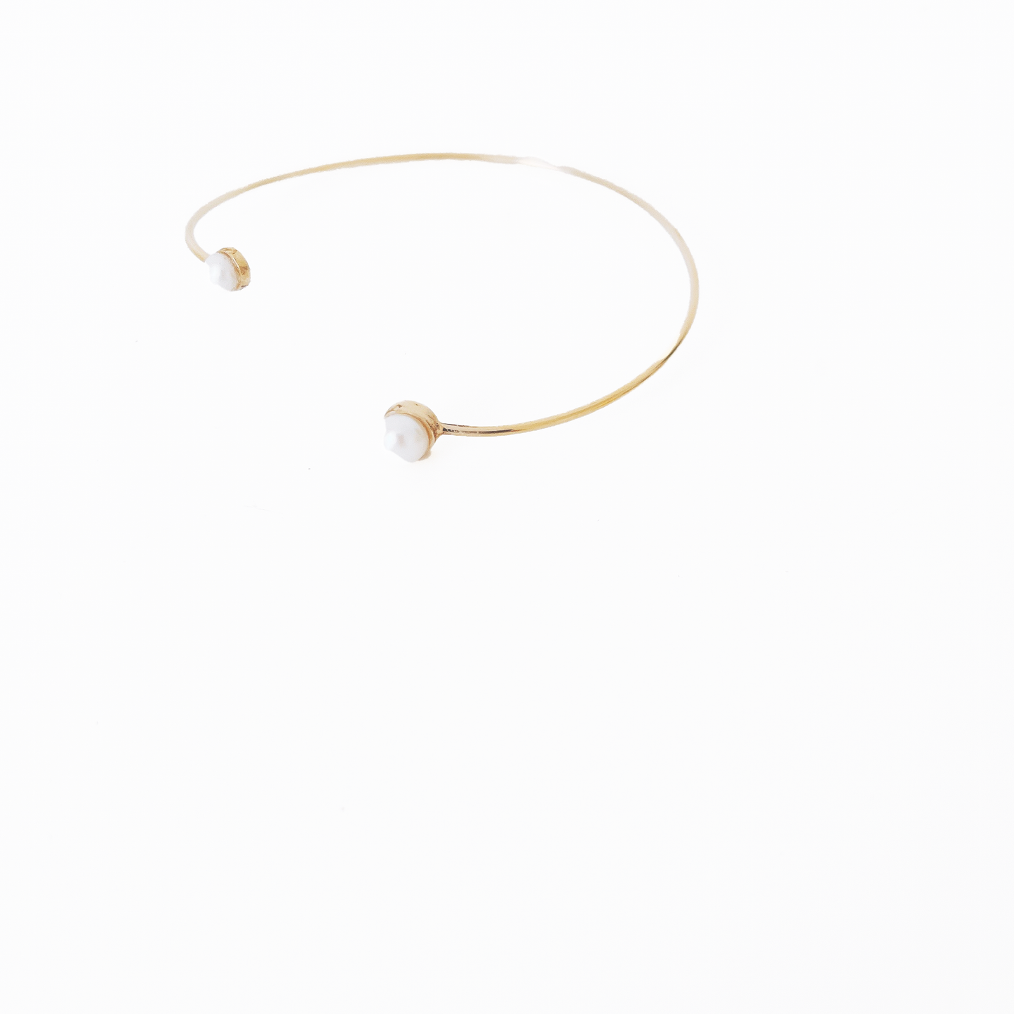 Open gold bracelet adorned with varying sizes of pearls by Hikaru Pearl