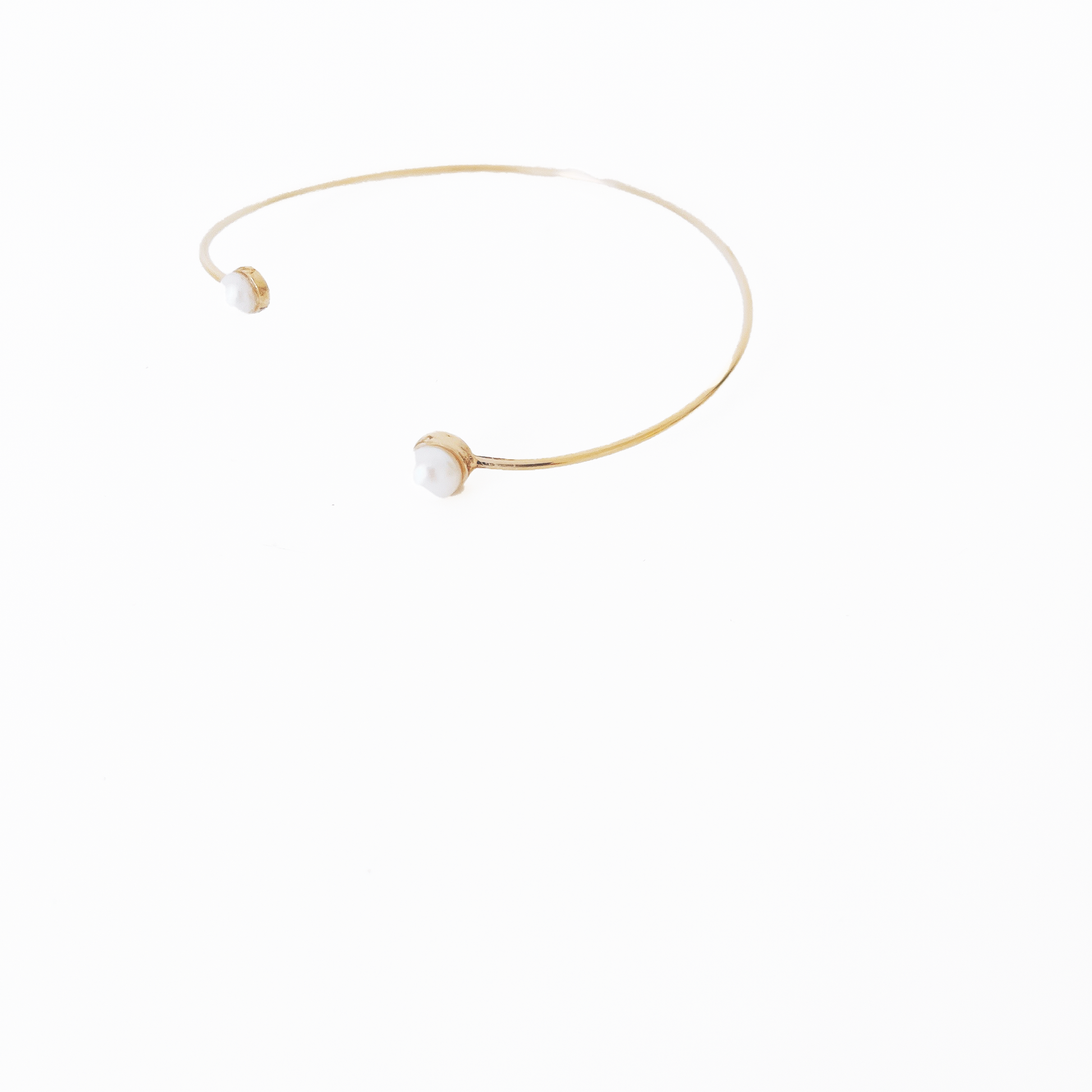 Open gold bracelet adorned with varying sizes of pearls by Hikaru Pearl